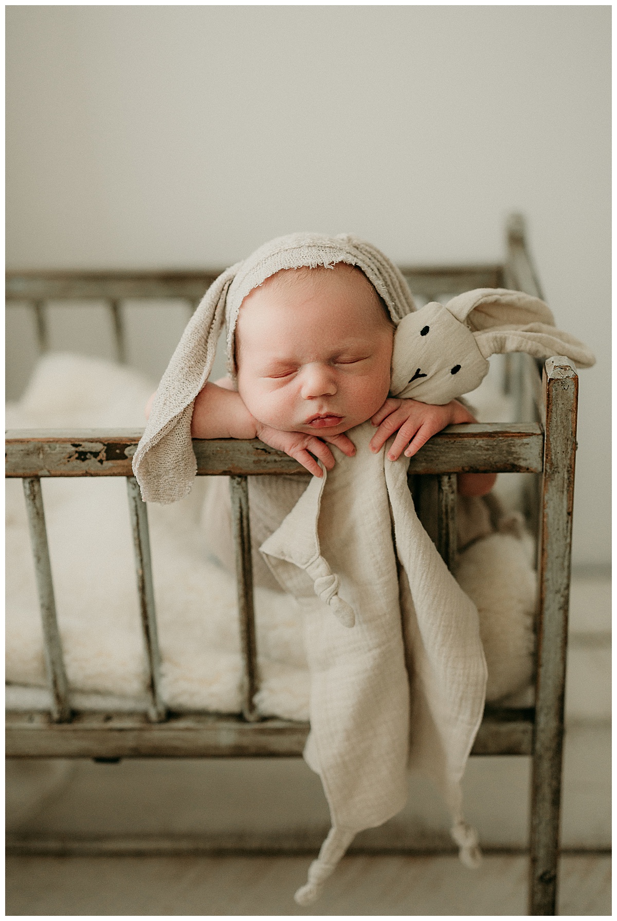 Baby rests head on wooden bassinet for Intimate Studio Newborn Session