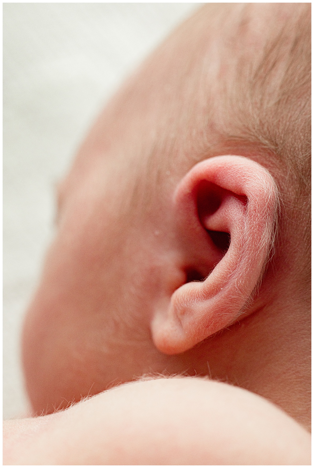 Newborn has precious fuzzy ear for Virginia Newborn Photographer 