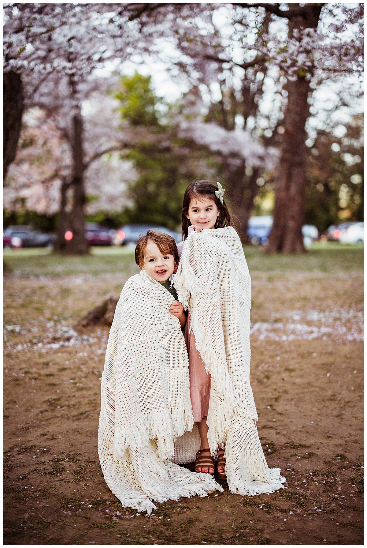 Young kids wrap up in a blanket for Norma Fayak Photography