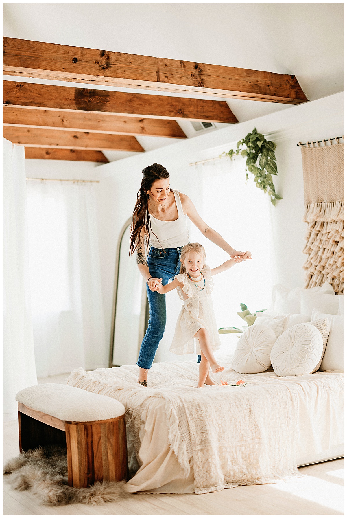 Mom and daughter jump and play on bed for Virginia Family Photographer