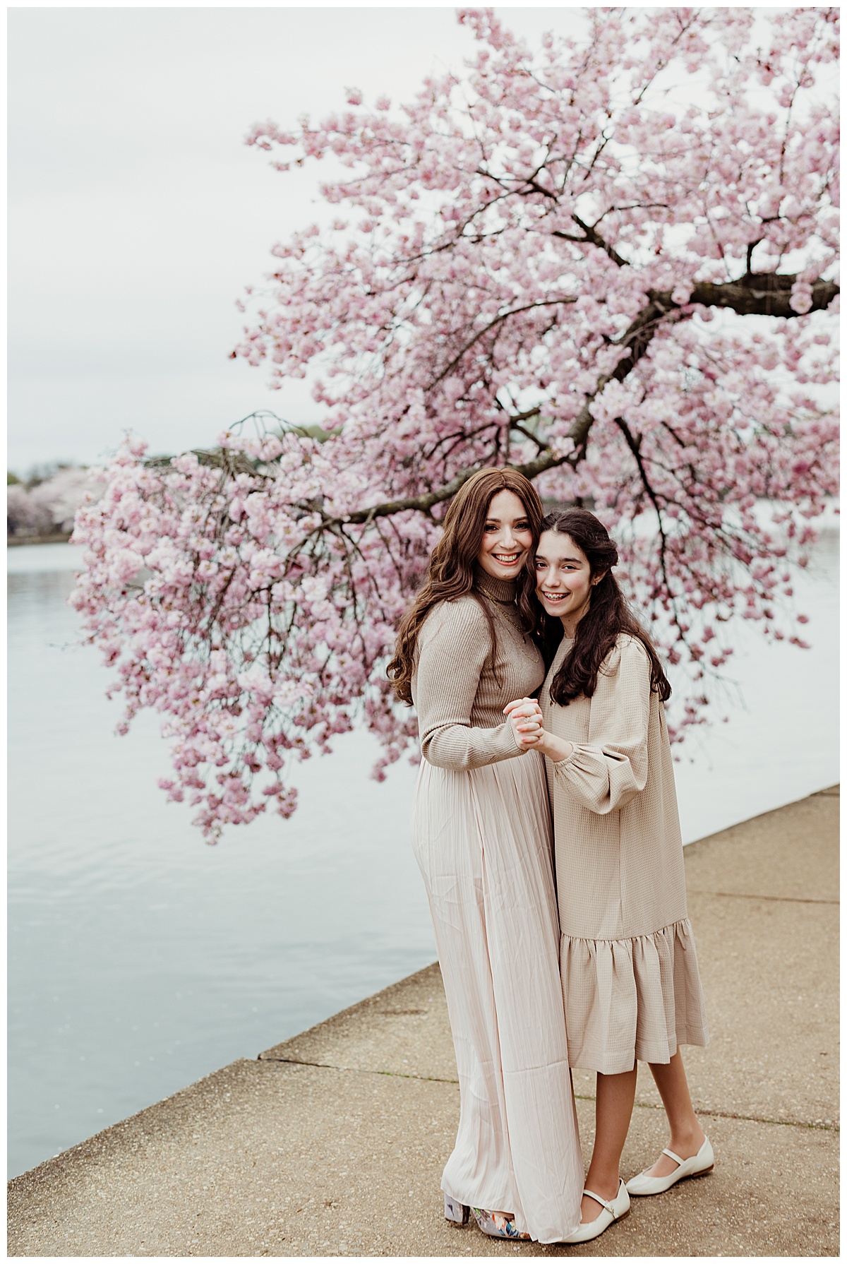 Mom and daughter hug one another for Cherry Blossom Family Photos