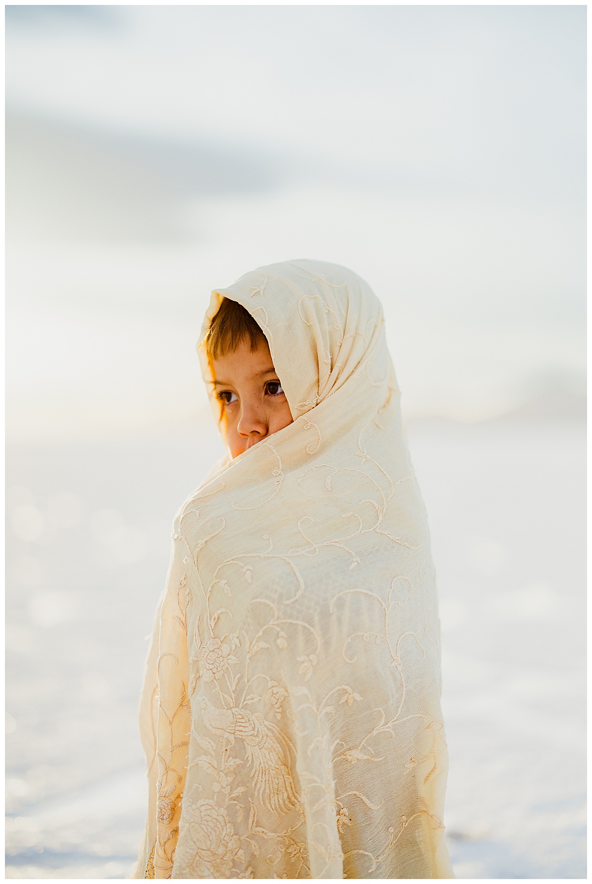 Little one wrapped in a blanket during their Bonneville Salt Flats Family Session