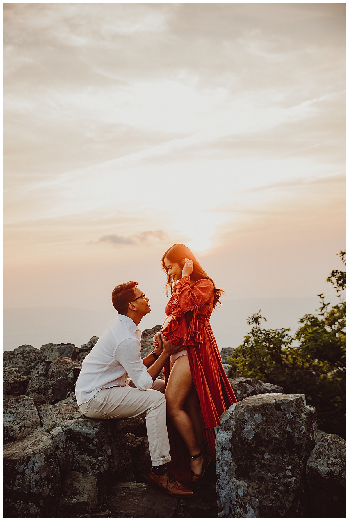 Couple smile at one another for Shenandoah Mountains Adventurous Maternity Session