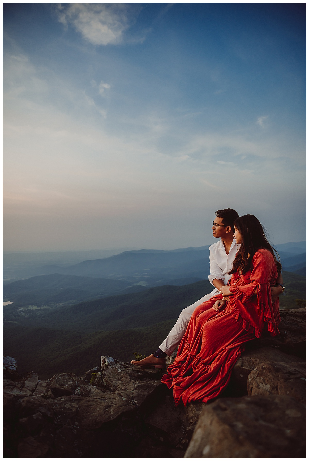 Couple sit on edge of mountains for their Virginia Maternity Photographer