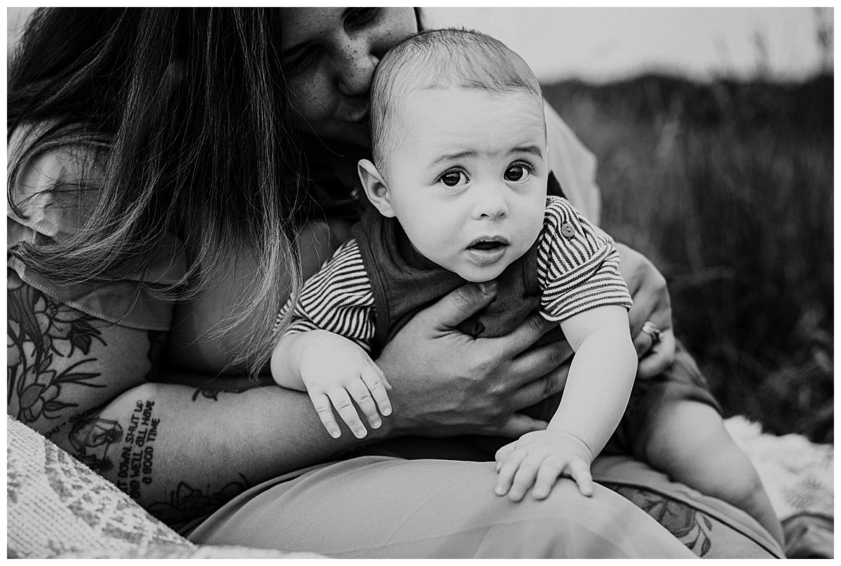 Baby lays on moms lap for Norma Fayak Photography