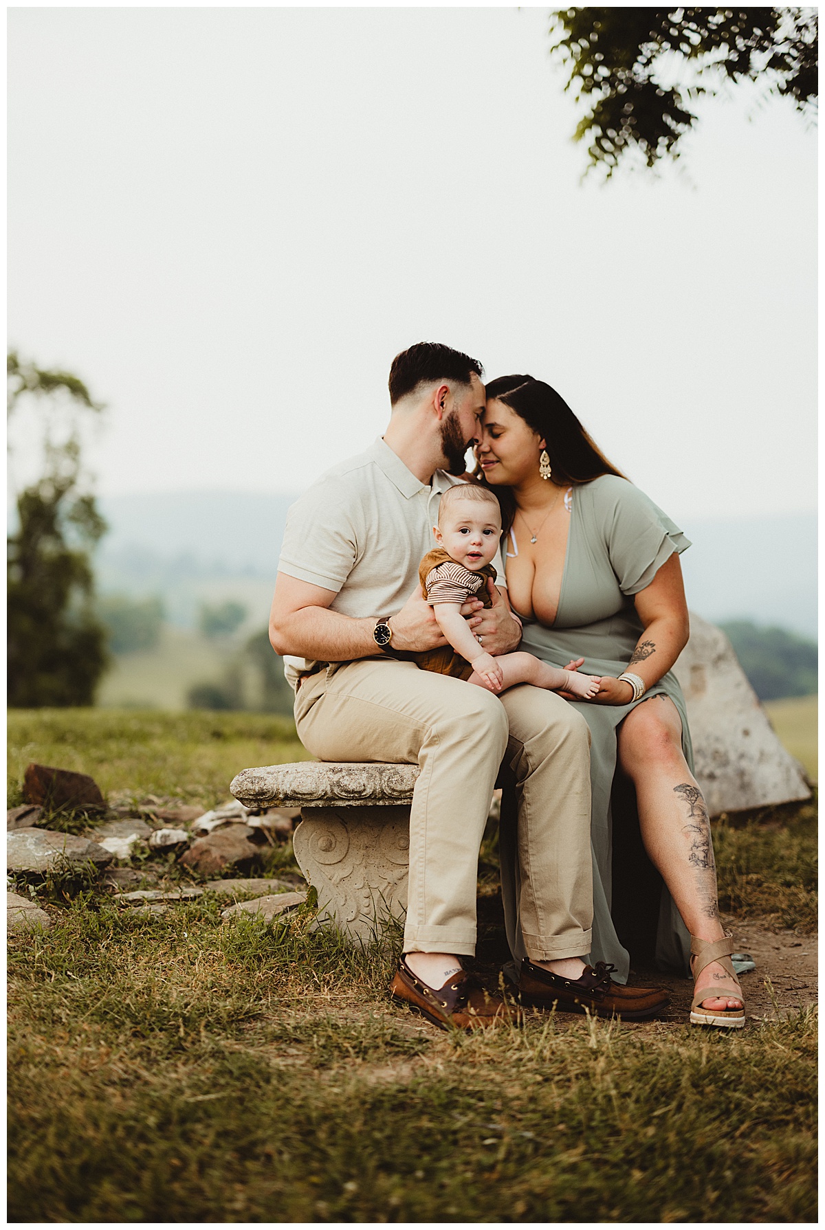 Mom and dad love on one another and hold baby close for Norma Fayak Photography