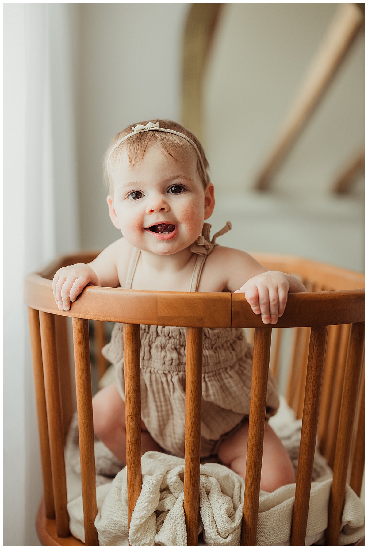 Little one stands up in crib for Virginia Family Photographer 