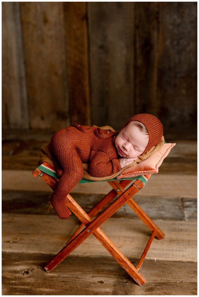 Young infant lays on seat for Norma Fayak Photography