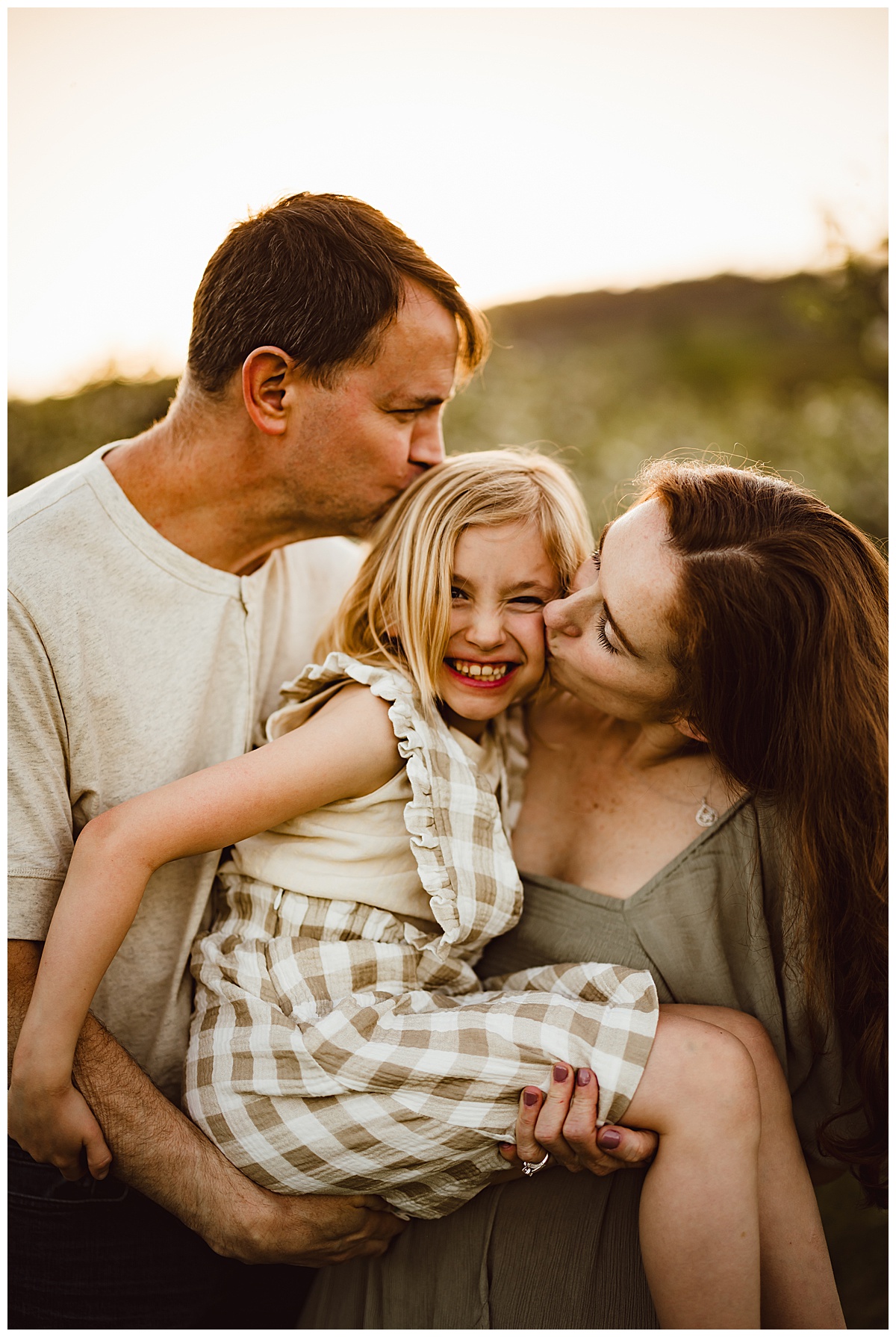 Parents hold older daughter together during their Blue Ridge Mountains Family Photos