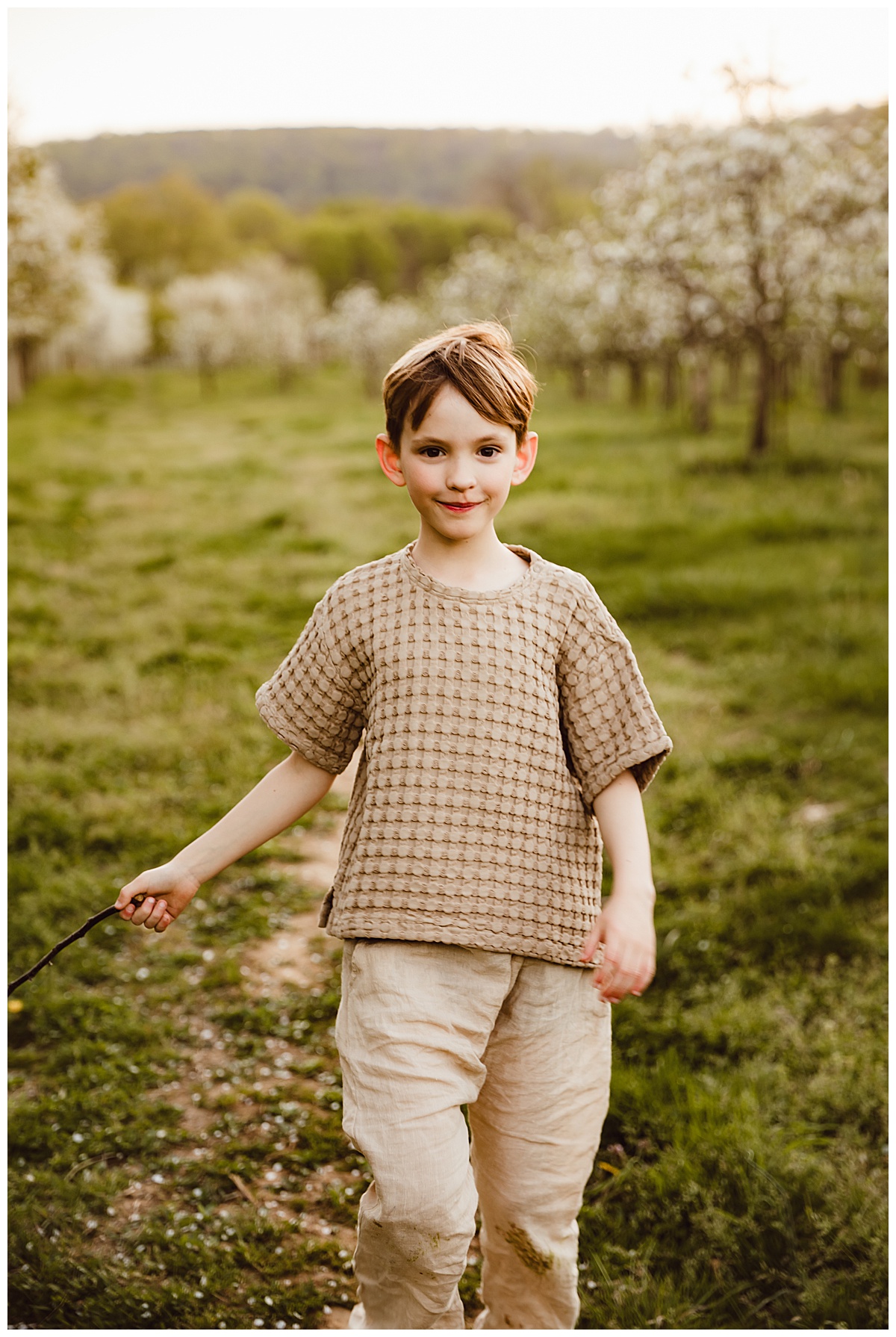 Sone walks through green field for Virginia Family Photographer