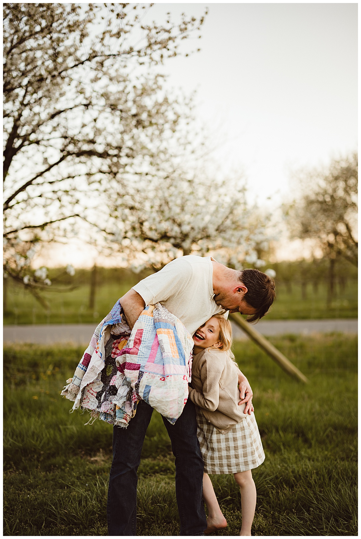 Dad holds child close for Norma Fayak Photography