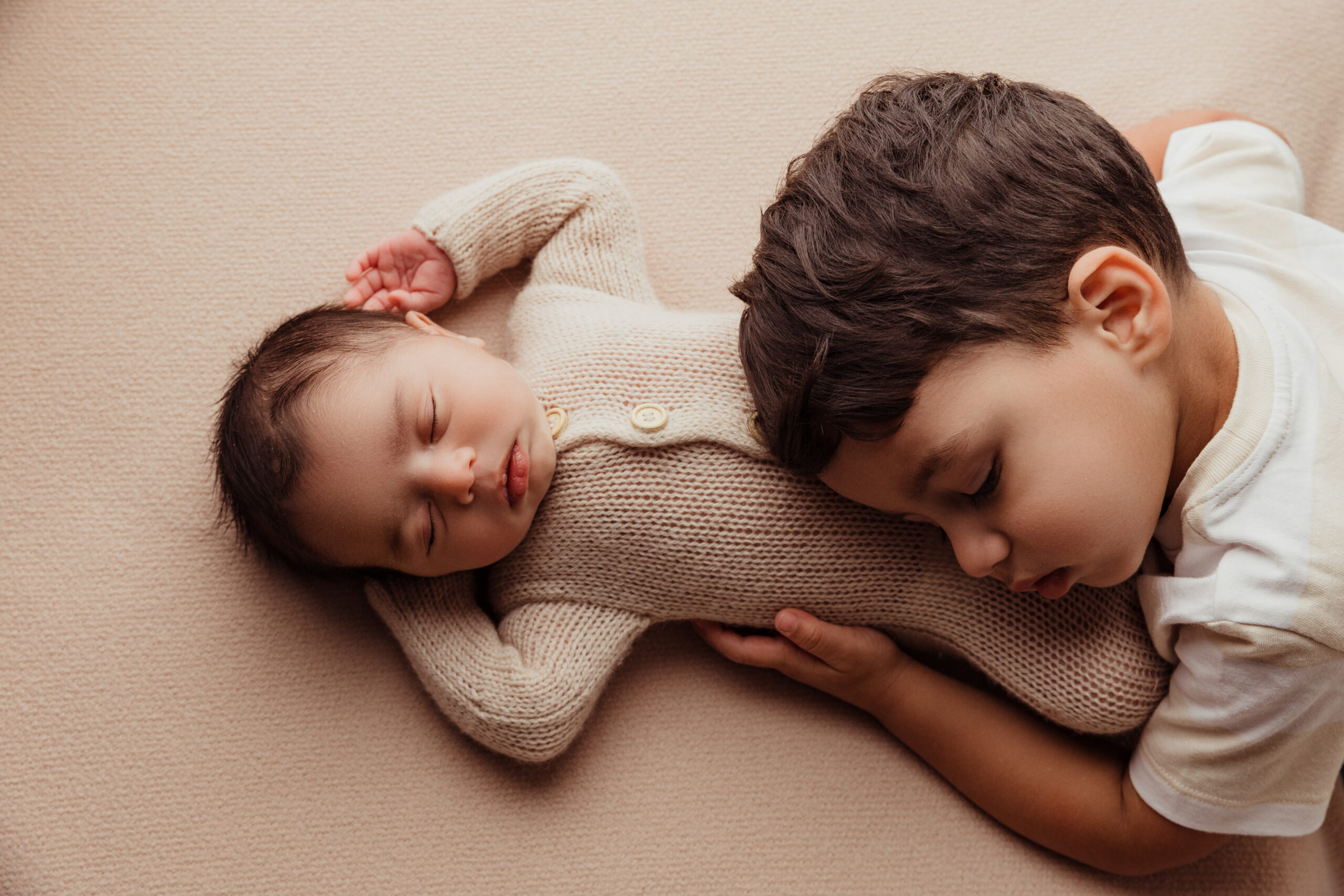 Toddler lays on baby brother for Norma Fayak Photography