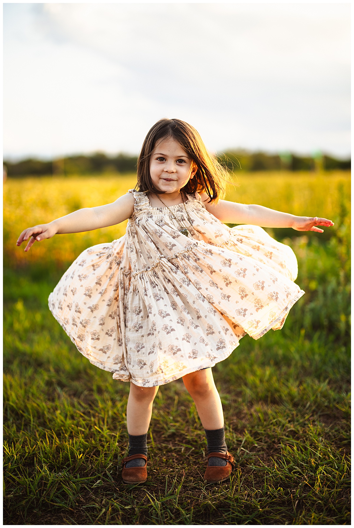 young girl twirls in dress for Sunflower Field Family Photos