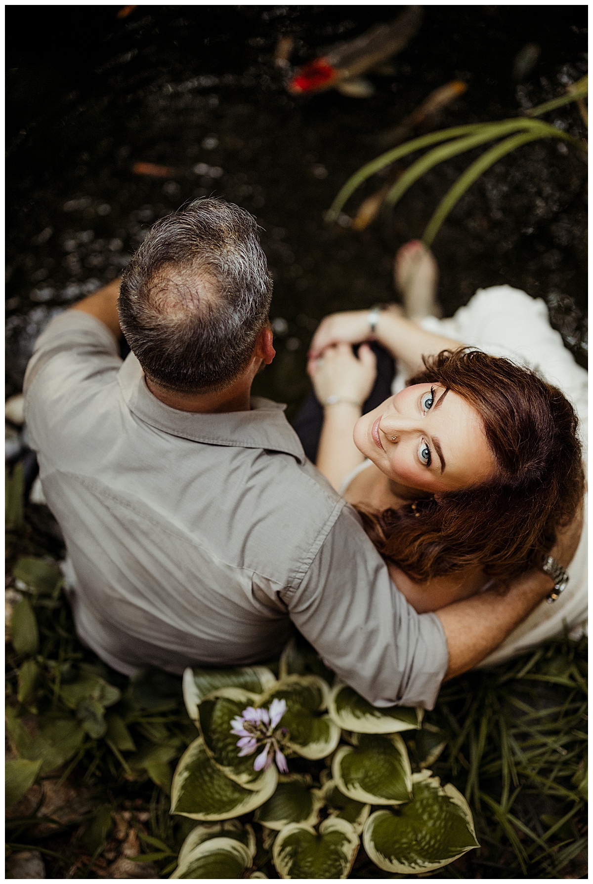 Parents smile together and sit near one another for Magical Backyard Maternity Session