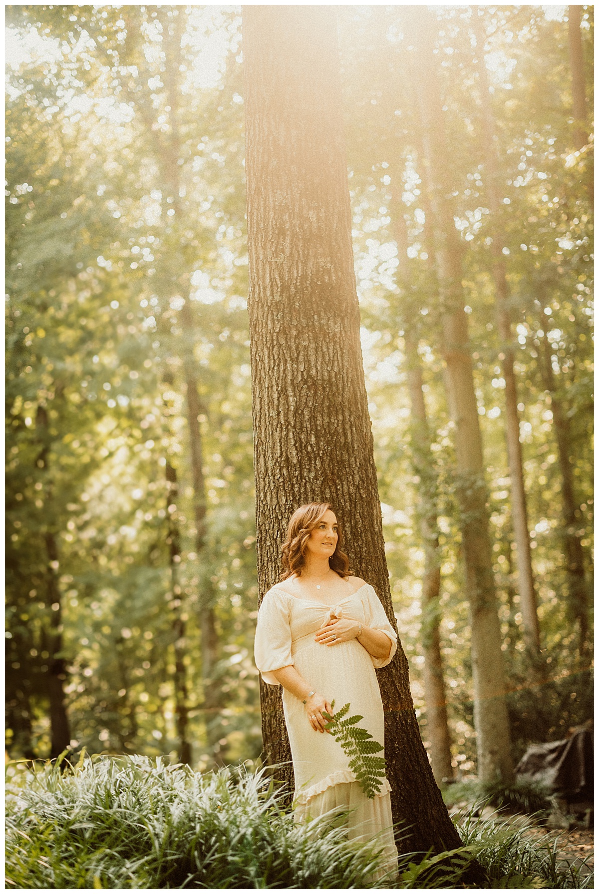 Mom hold pregnant belly for Magical Backyard Maternity Session
