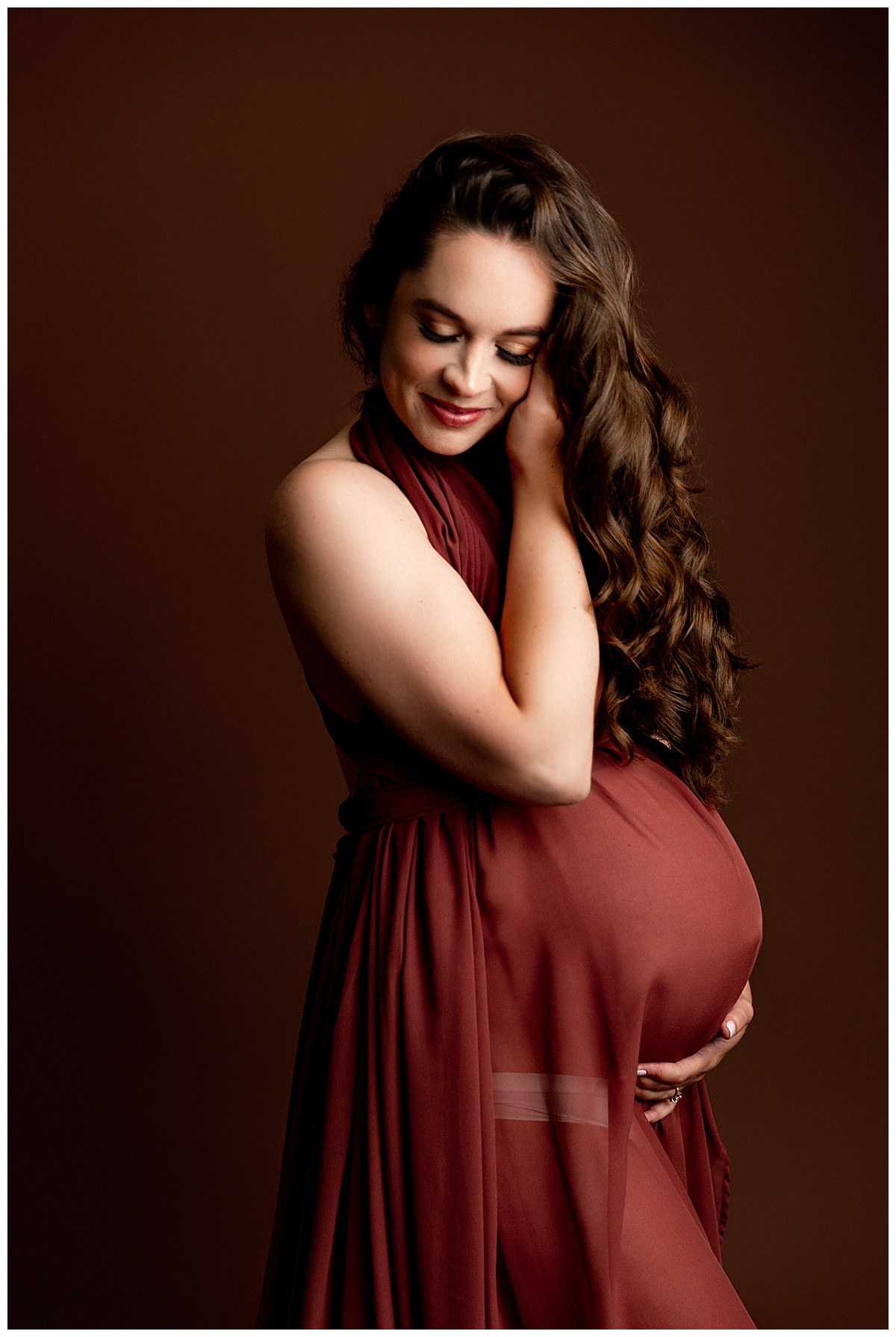 Mom to be holds pregnant belly and smiles big for Virginia Maternity Photographer
