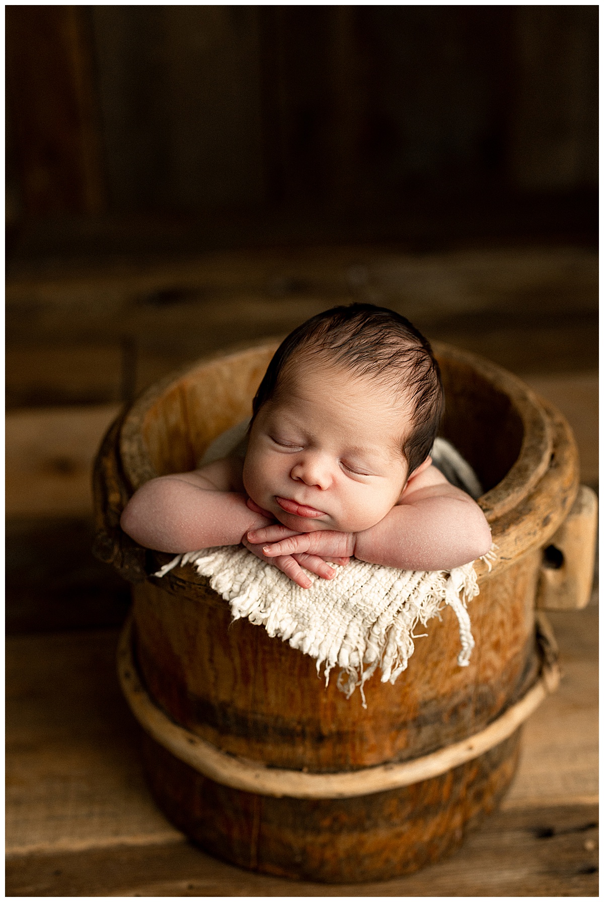 Baby sleeps in a basket for Norma Fayak Photography