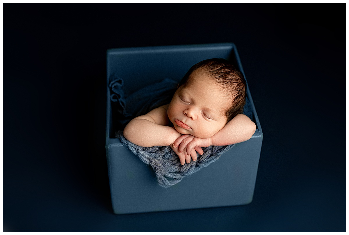 Baby sits in a box for Norma Fayak Photography