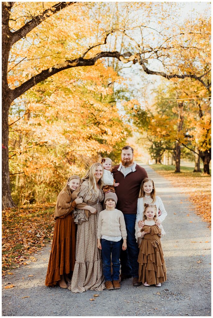 Family smiles together wearing Neutral Color Palette For Family Photos