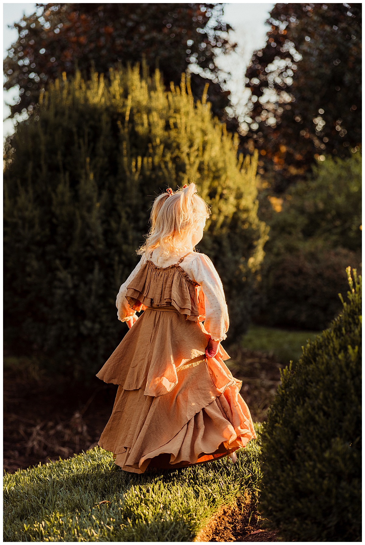 Young girl walks through lush greenery for Norma Fayak Photography