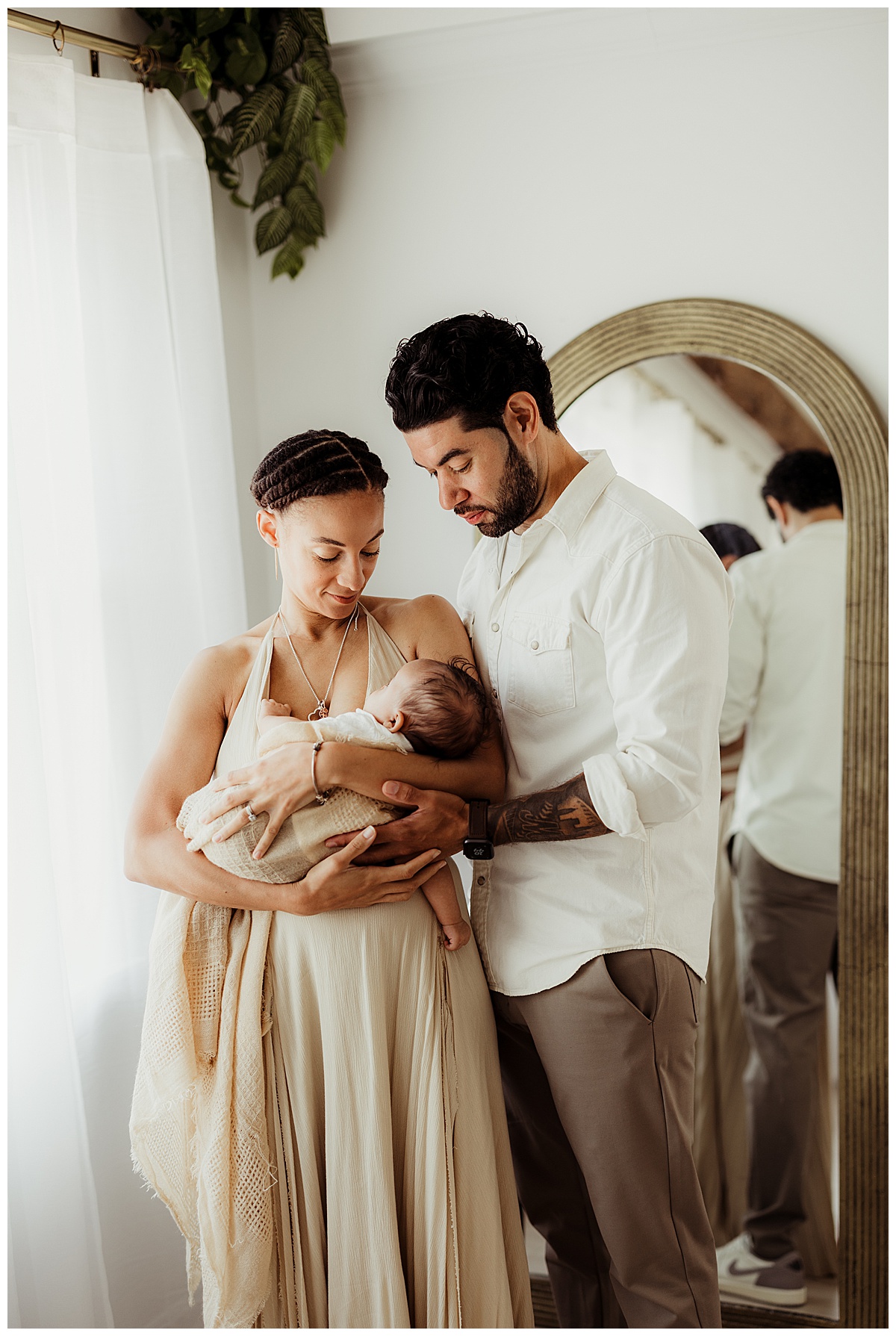 Mom and dad holds baby close during her Lifestyle Newborn Session