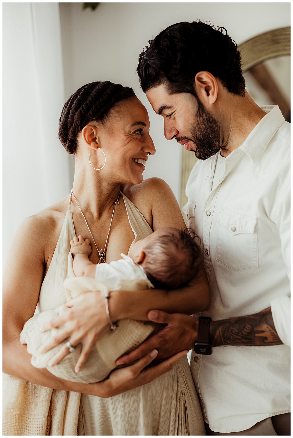 Mom smiles at dad holding her little one for Virginia Newborn Photographer