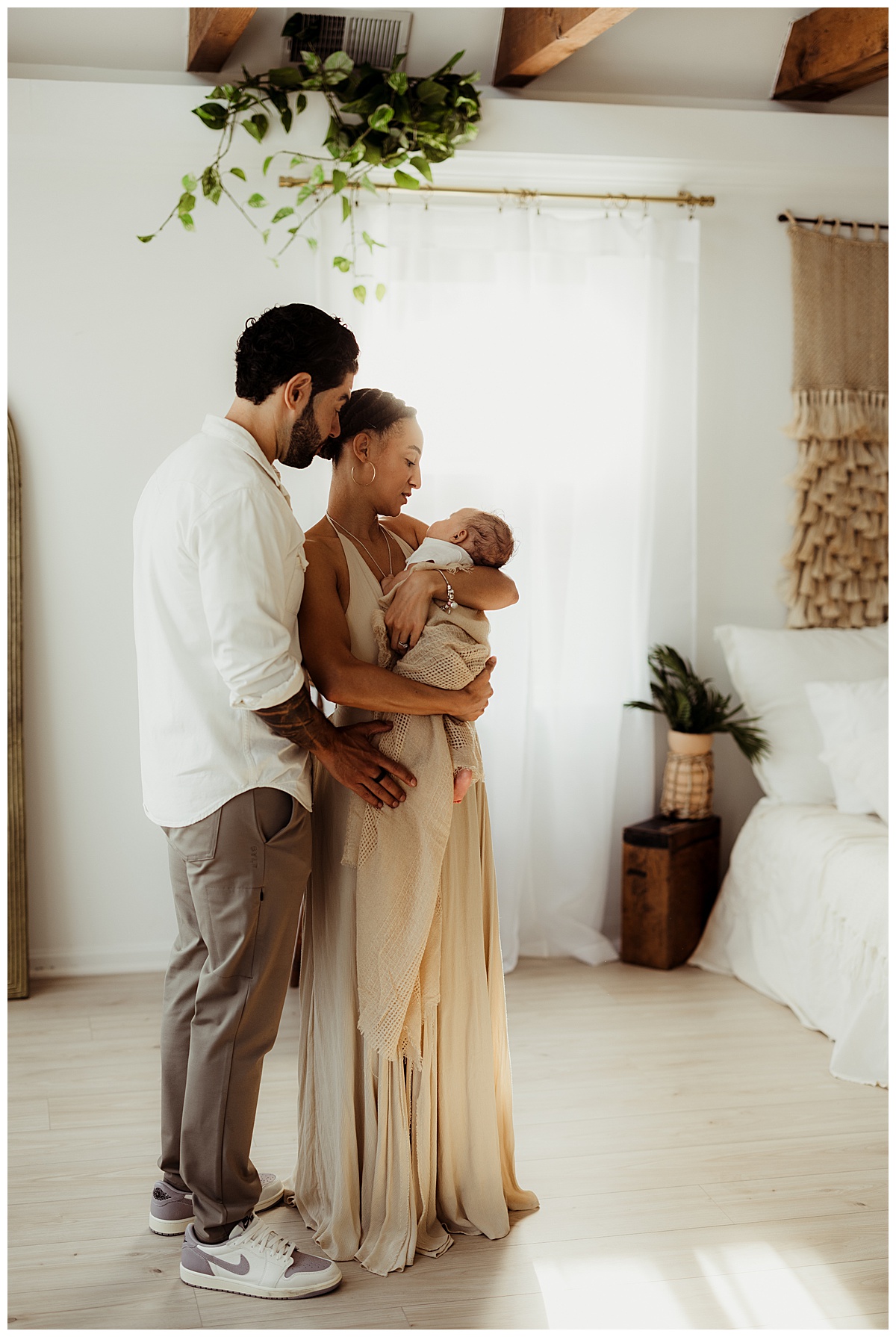 Parents smile at their baby during their Lifestyle Newborn Session