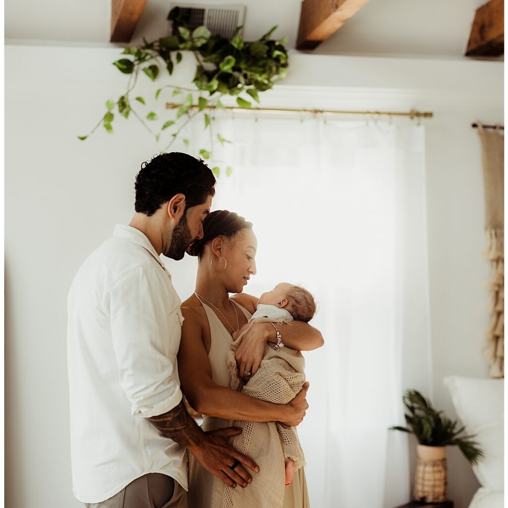 Parents smile at their little one for Virginia Newborn Photographer