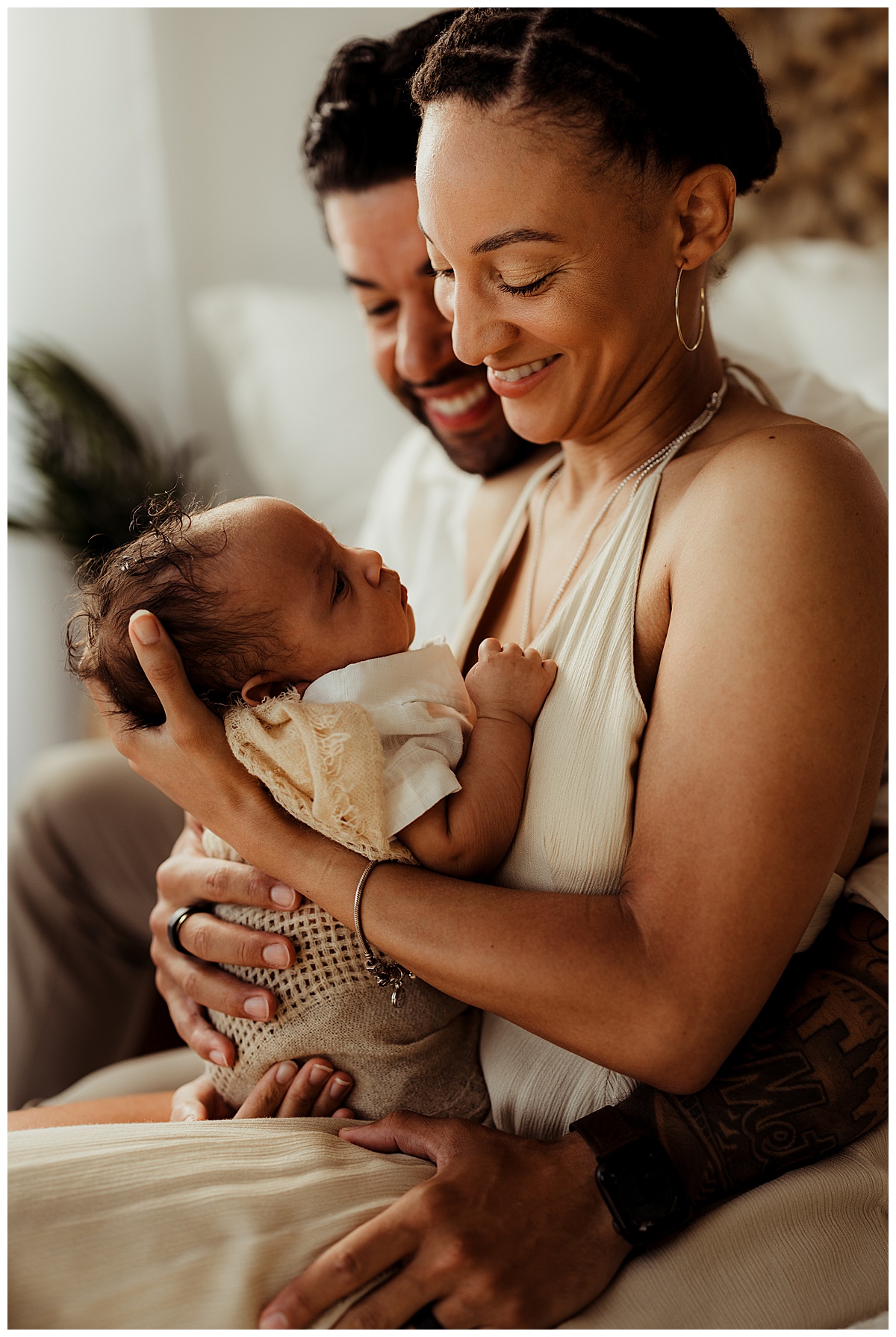 Parents smile at their baby during their Lifestyle Newborn Session