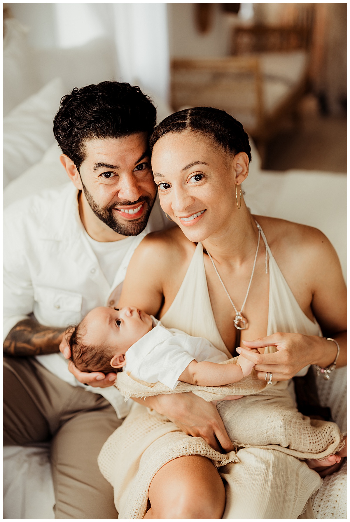 Parents smile while holding their baby for Norma Fayak Photography
