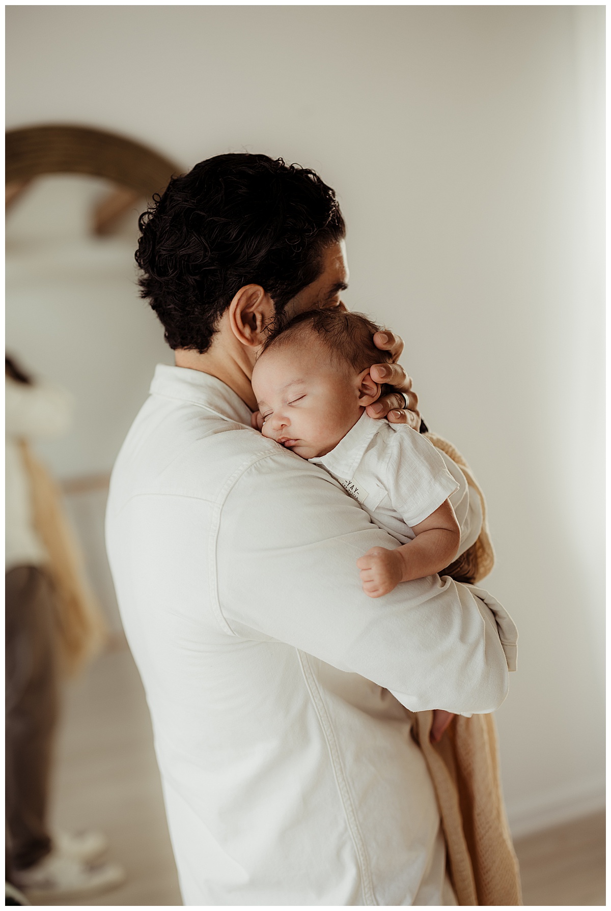 Son holds baby close for Norma Fayak Photography