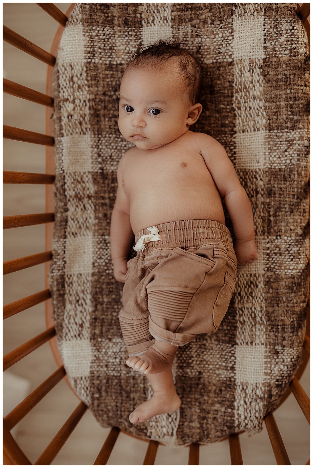 Young baby lays on the blanket for Norma Fayak Photography