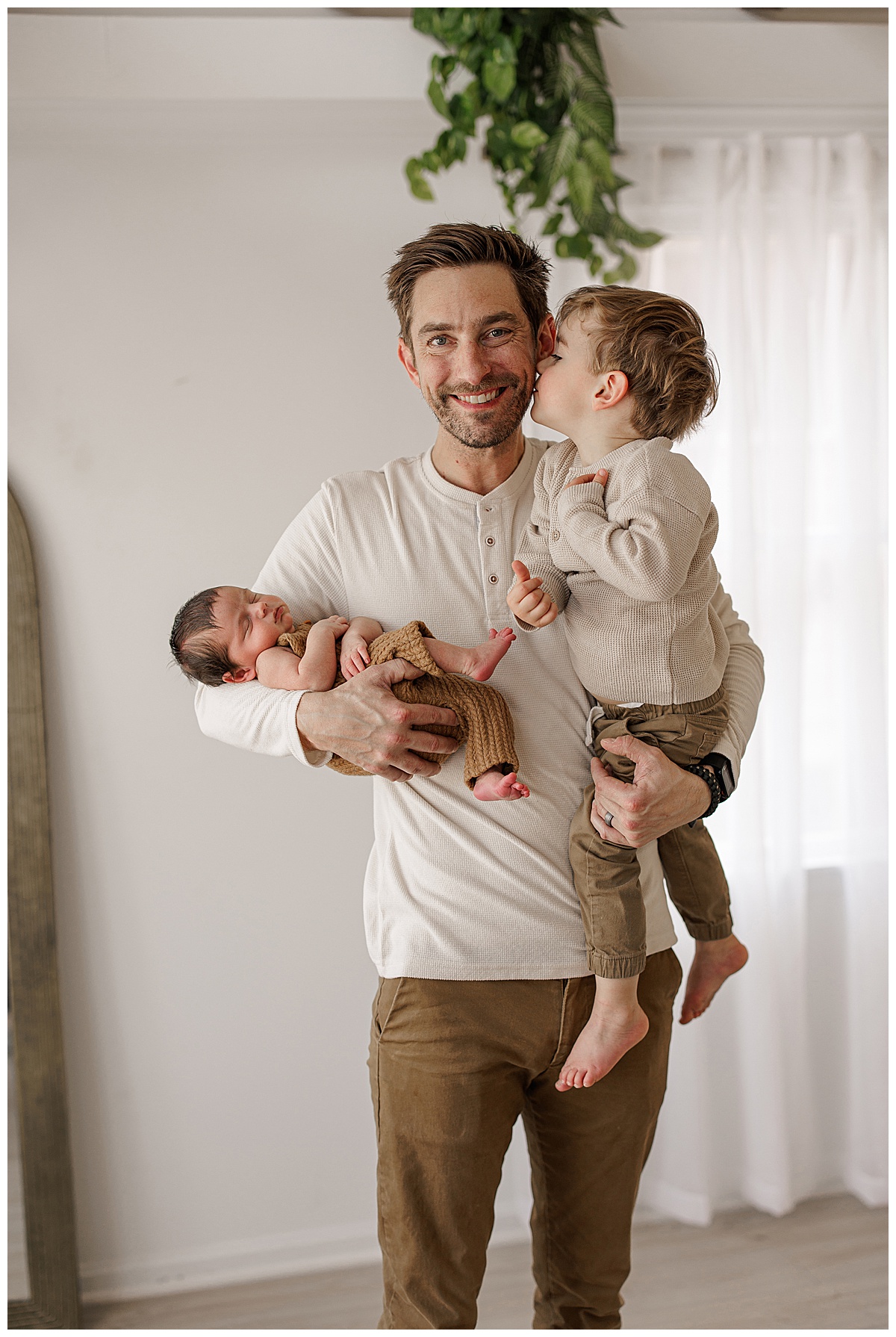Dad holds two children for Virginia Newborn Photographer