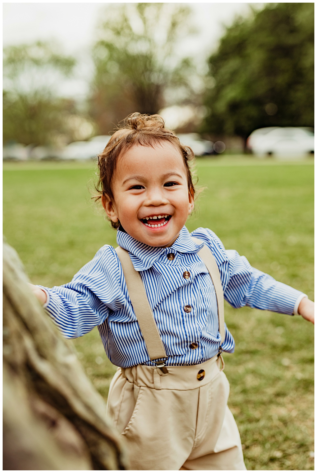 Little boy runs and smiles big during Washington, DC, Cherry Blossom photos