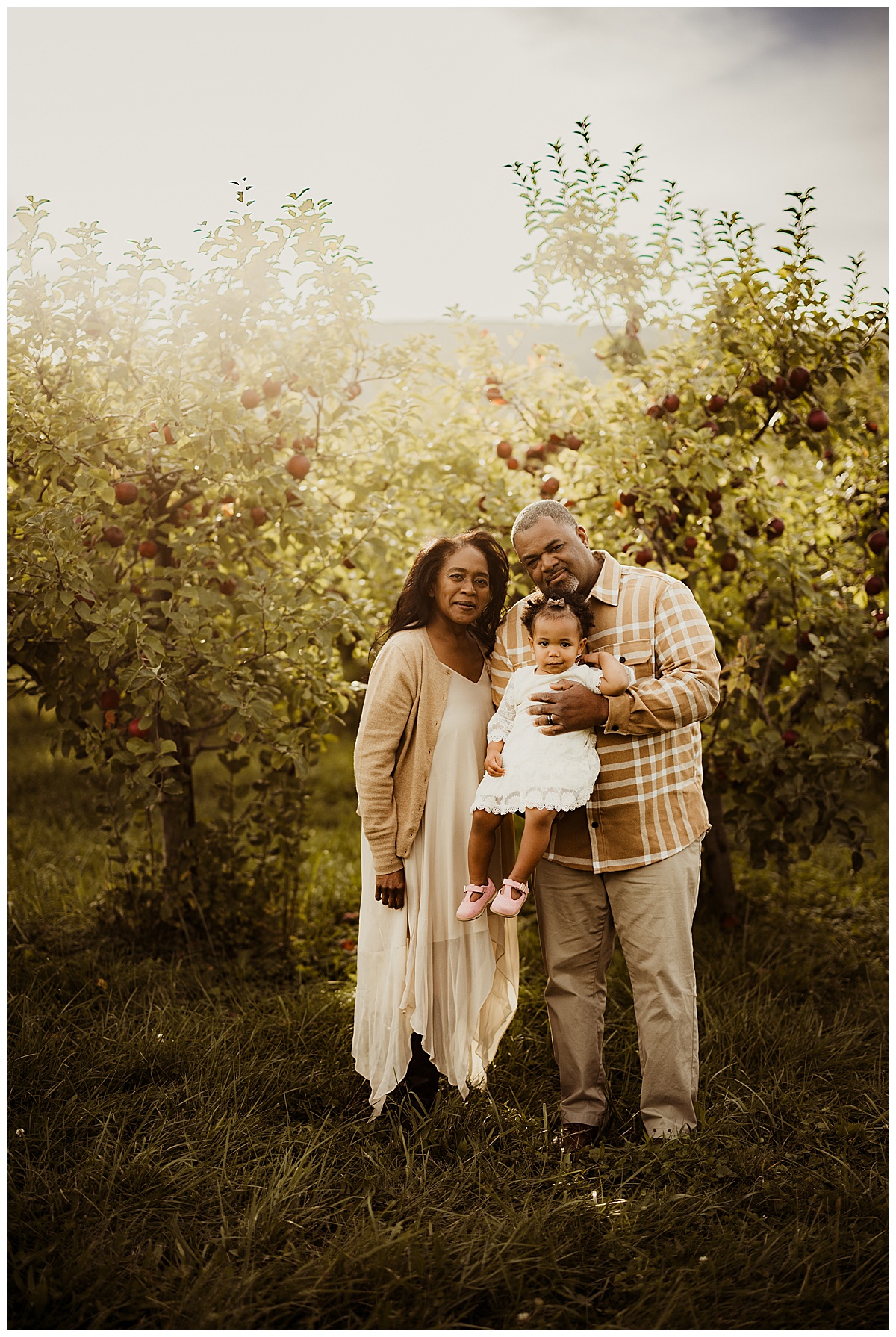 Family holds their young daughter close during their Virginia Family Photographer 