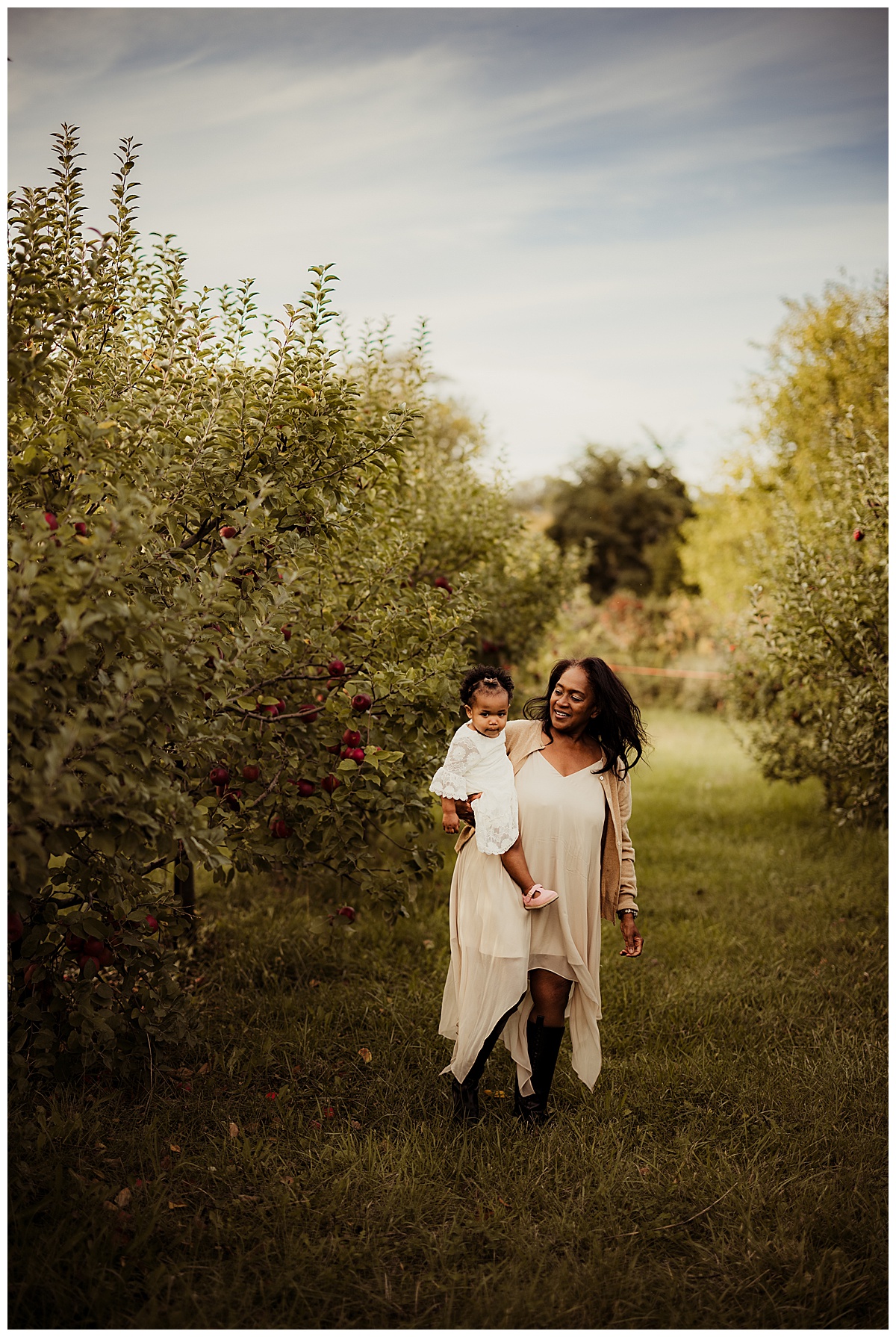 Mom holds young daughter for Outdoor Adventure Golden Hour Session at Great Country Farms