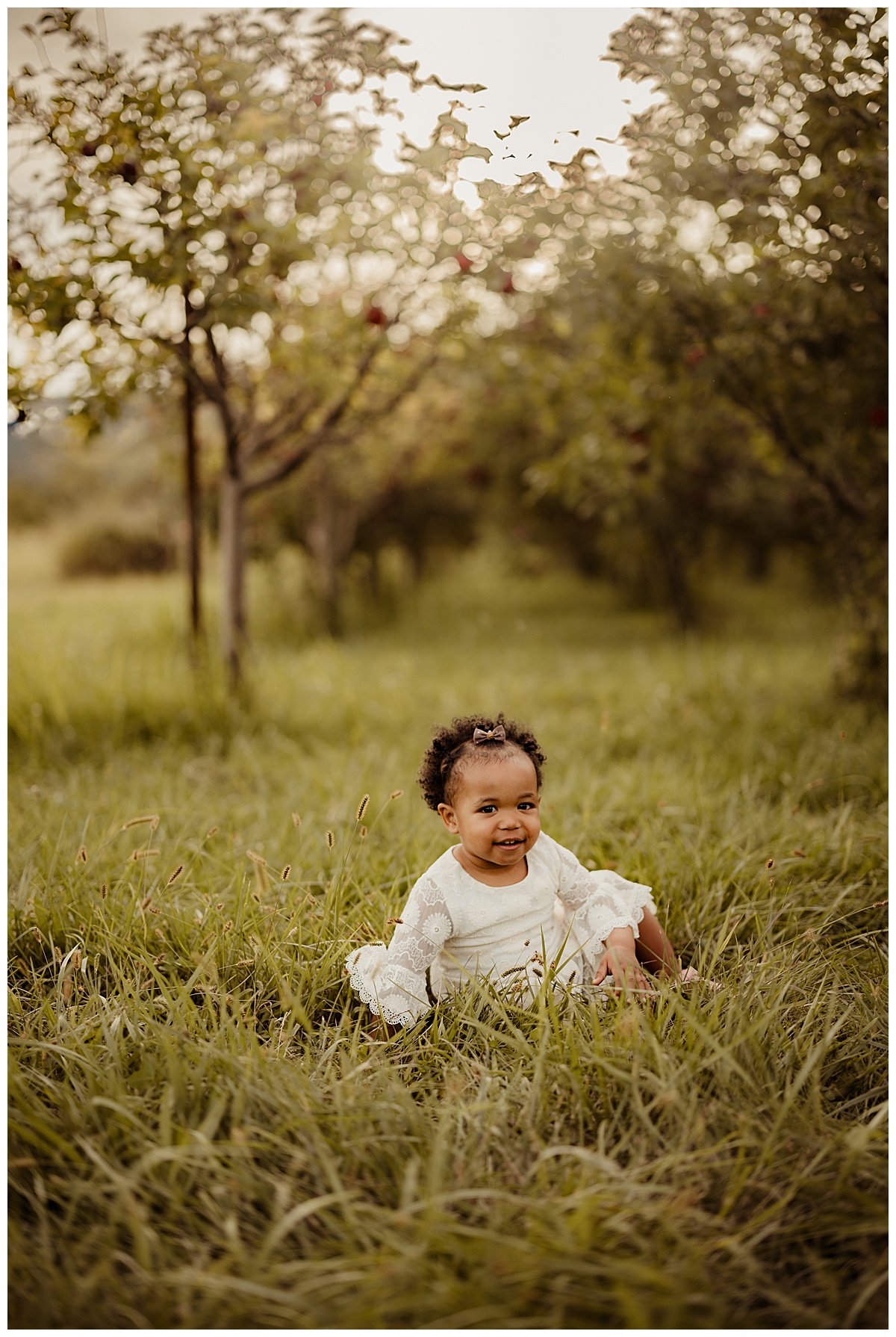 Baby girl smiles during their Outdoor Adventure Golden Hour Session at Great Country Farms