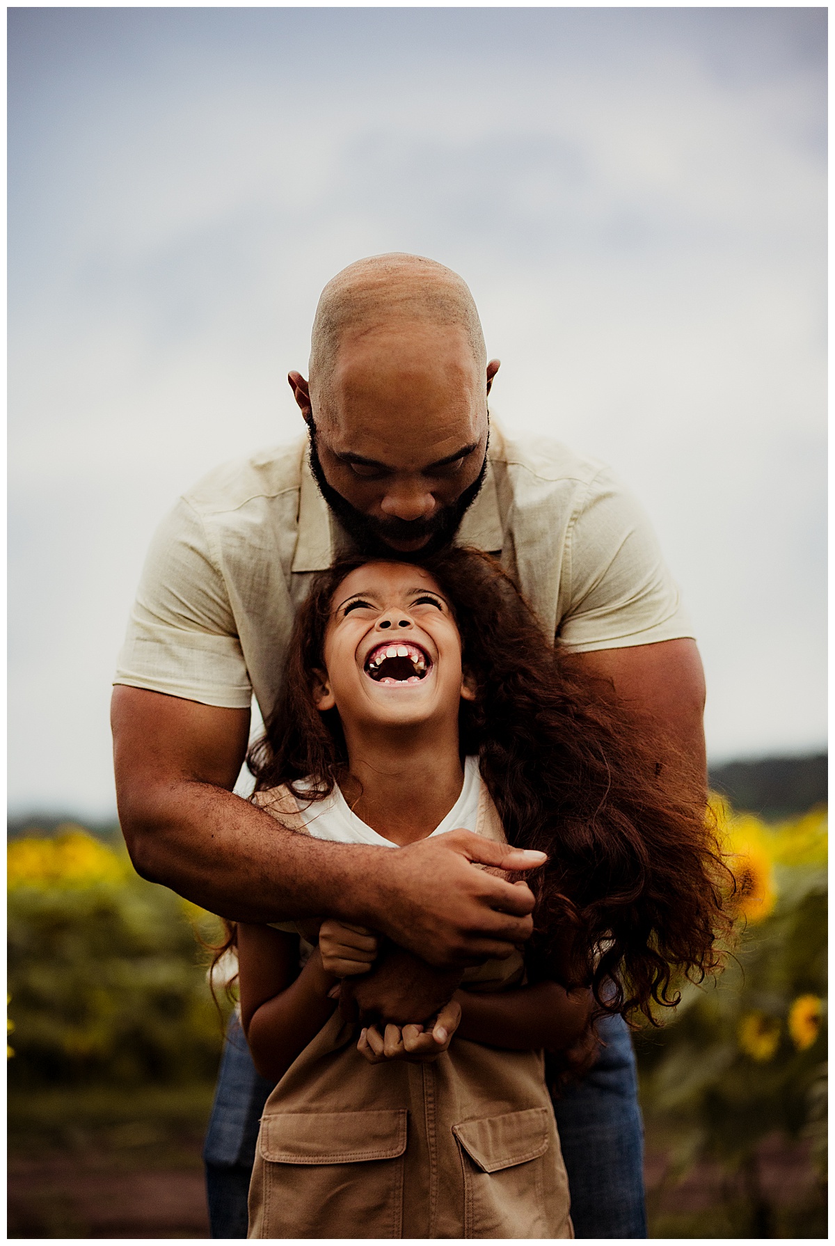 Dad and daughter smile at one another for Norma Fayak Photography
