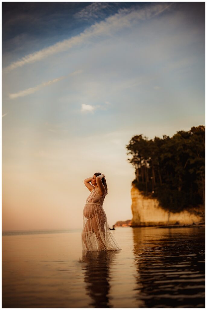 Mom stands in the water during her Lakeside Maternity Session