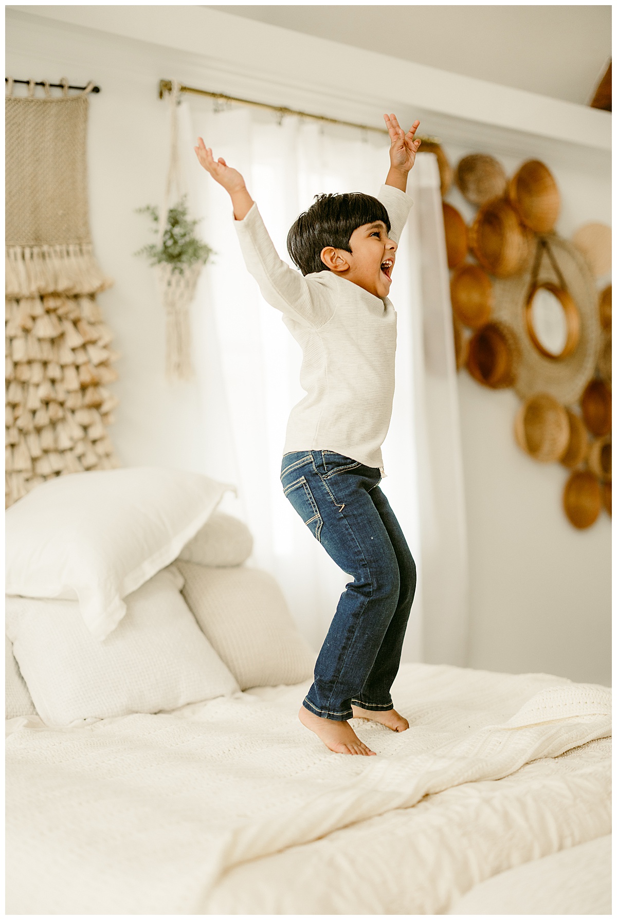 Young boy jumps on the bed for Virginia Family Photographer