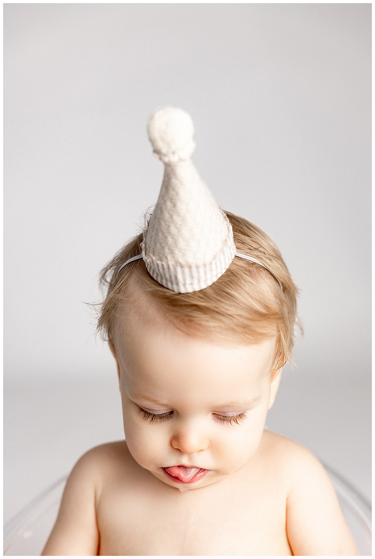Young child wears birthday hat for Norma Fayak Photography