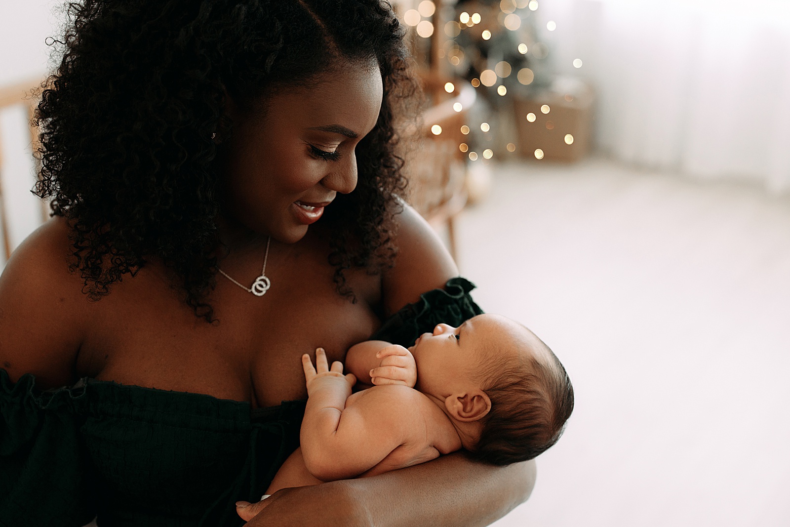 Mom holds young baby for Lifestyle Newborn Session