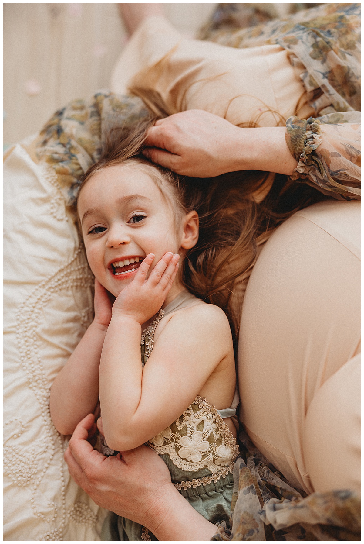 Pregnant mom embraces belly and young daughter for Norma Fayak Photography