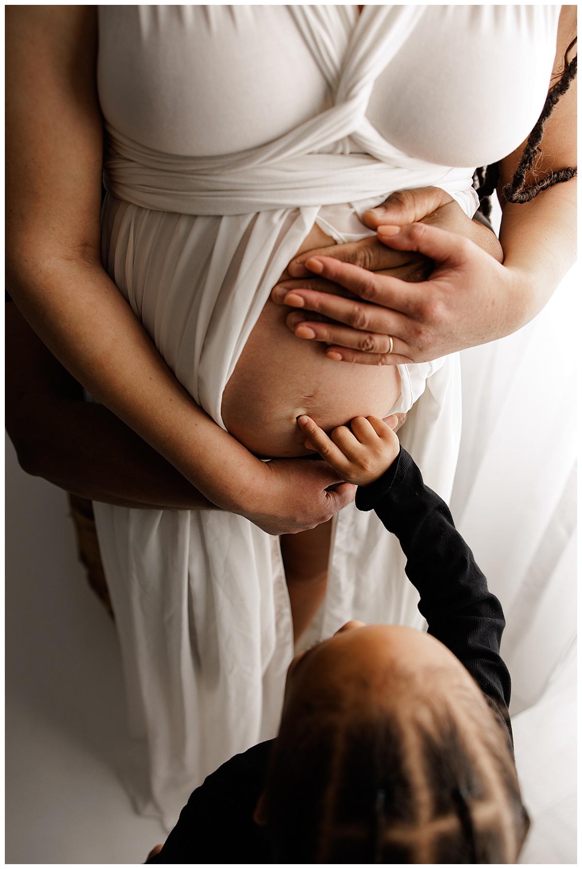 Young boy touches moms baby bump for Virginia Maternity Photographer