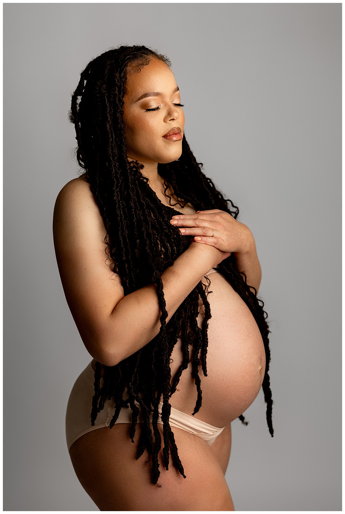 Mother covers chest with hands for Virginia Maternity Photographer