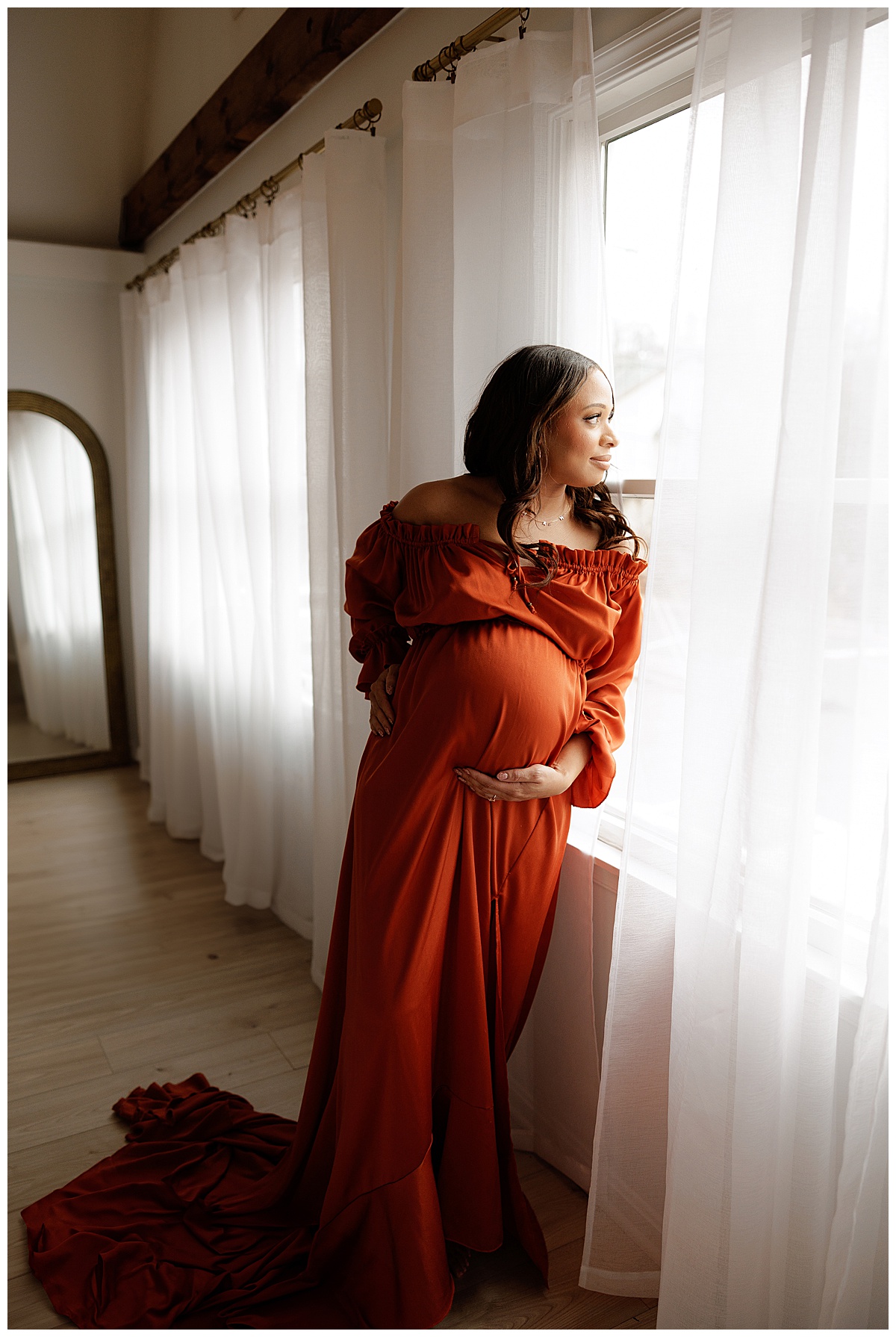 Woman embraces baby bump for Norma Fayak Photography