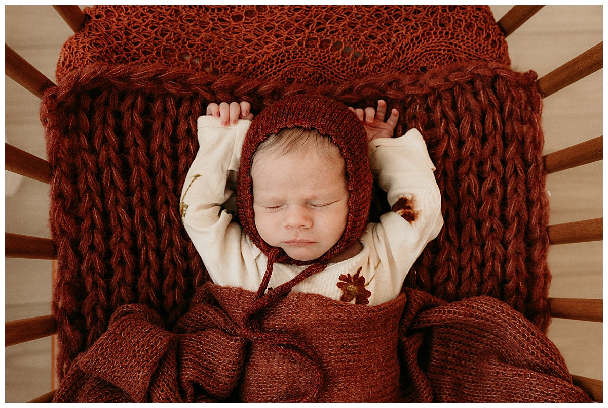 Baby lays down with hands up for Norma Fayak Photography